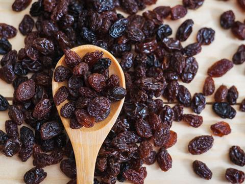 Raisins on a wooden spoon