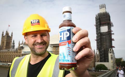 Builder holding bottle of Heinz HP Sauce