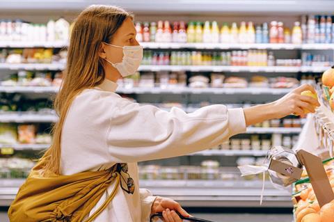 woman in mask in supermarket coronavirus