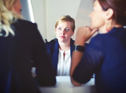 Young woman being interviewed in an office