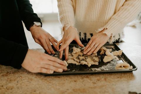 couple cooking baking christmas biscuits