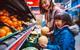 happy family fruit aisle supermarket shopper melon