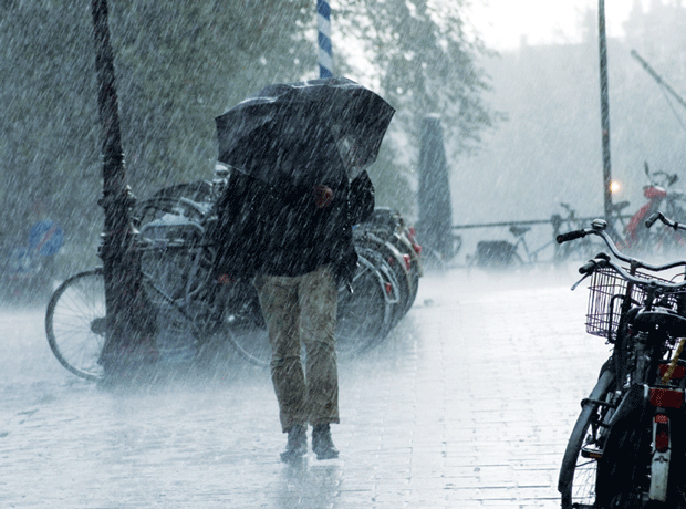 Man with umbrella in rain weather