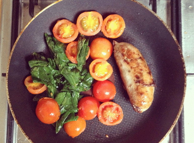 Paleo Gluten-free pork and herb sausage, cherry tomatoes and fresh spinach, fried in ghee