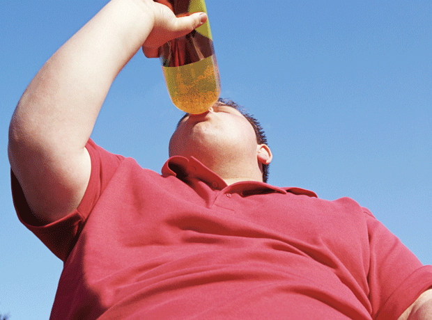 obese boy drinking soft drink