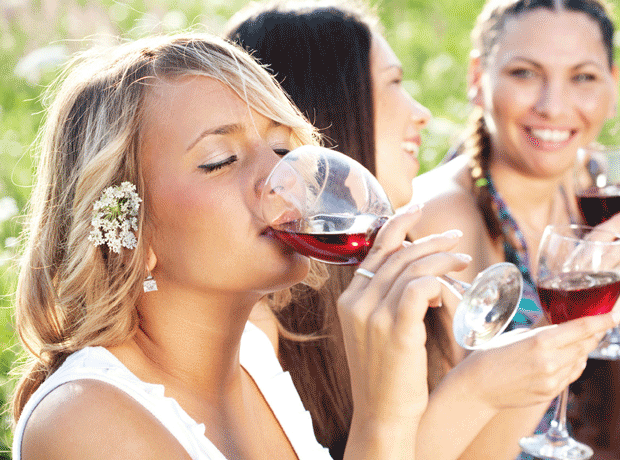 Women in park drinking wine